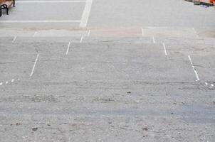 A grey concrete sidewalk with a white line painted down the middle. The sidewalk is empty and has no people or objects on itv photo