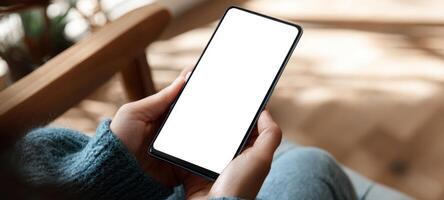 The smartphone held by a person in a cozy indoor setting. photo