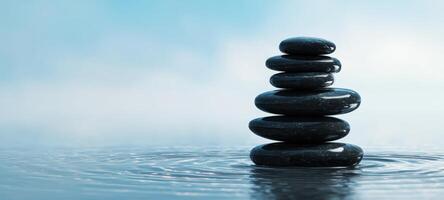 The Stacked Stones Eliciting Calm and Serenity on Tranquil Water Surface photo