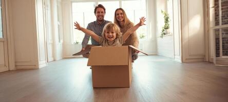 The joyful child playing in a cardboard box with loving parents nearby. photo