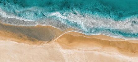 The stunning beachscape blending turquoise waters with golden sandy shores. photo