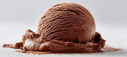 The delightful chocolate ice cream scoop melting on a surface. photo