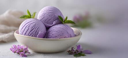The elegant bowl of creamy purple ice cream garnished with fresh mint. photo