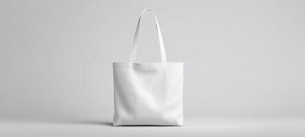 The minimalist white tote bag on a simple gray background. photo