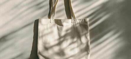The stylish beige tote bag with soft shadows on a neutral background. photo