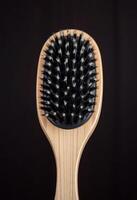 close up of a wooden brush on a black background photo