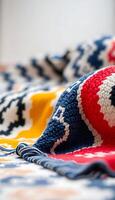 A colorful blanket is laying on top of a bed photo