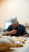 man in a chef's hat standing in front of a line of past photo