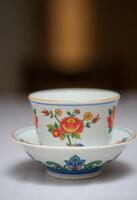 A chinese tea cup and saucer with a flower design photo