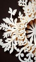 close up of a snowflake on a black surface photo