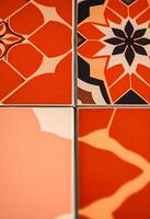Four different colored tiles with designs on them photo