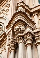 The ornate columns of a building are shown photo