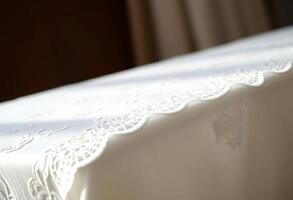 A white table cloth with lace on it photo