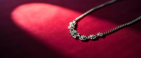 diamond necklace is shown on a red surface photo
