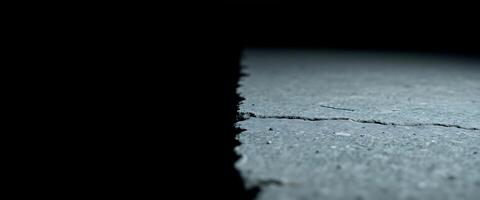 A close up of a crack in the road photo