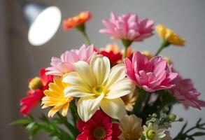 A vase filled with colorful flowers is shown in front of a light photo