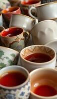 table topped with lots of cups filled with liquid photo