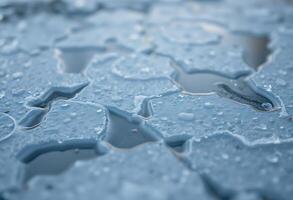 A close up of water droplets on a surface photo