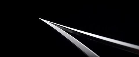 close up of a pair of scissors in the dark photo
