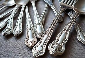 bunch of silverware sitting on top of a table photo