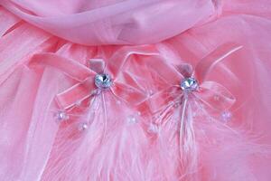 Delicate Pink Decorations Elegant Fabric Adornments with Feathers and Sparkling Jewels for Fashion. photo