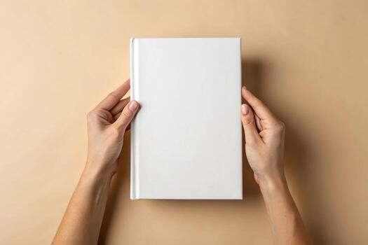 Blank book mockup held by hands on a neutral color background photo