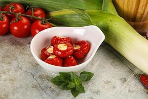 A bowl of tomatoes, peppers and corn on a table photo