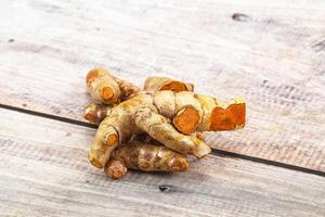 A close up of a ginger root on a wooden surface photo