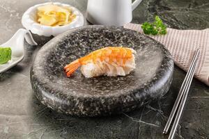 A plate with a shrimp and some chopsticks on it photo