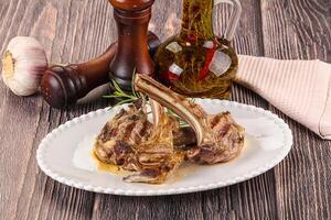 A plate with some meat and garlic on it photo