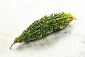 A green pepper on a white surface photo