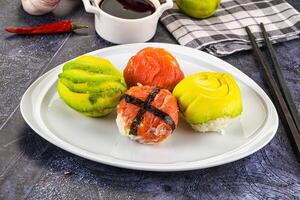 A plate with sushi on it and chopsticks photo