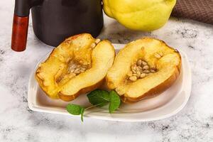 A white plate topped with a half of a peach photo