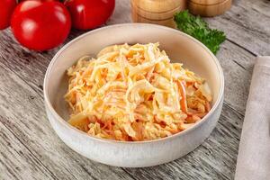 A bowl of shredded cabbage with tomatoes and parsley photo
