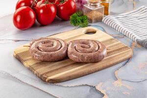 Raw meat pork and beef swirl sausages photo