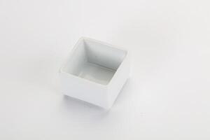 A white square container with a small hole in it photo