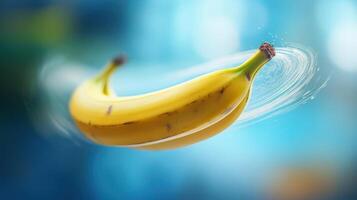 Floating banana with water droplets against a blue background. photo