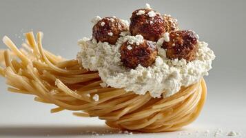 Spaghetti nest with meatballs and cheese. photo