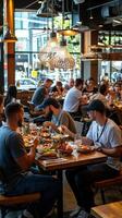 People eating at a restaurant in a large dining room photo
