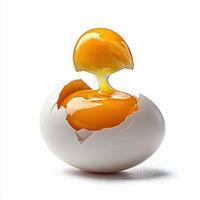 An egg is cracked open with a yellow liquid inside photo