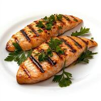 Two grilled salmon fillets on a white plate photo