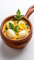 Eggs in curry with basil leaves photo