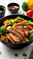 A bowl of chicken, vegetables and other ingredients photo