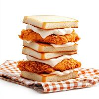 A stack of chicken sandwiches on a white table photo