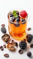 A cup of tea with berries and mint leaves photo