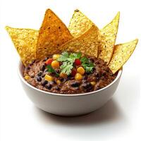 A bowl of black bean dip with tortilla chips photo