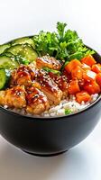 A bowl of rice, vegetables, and chicken with sauce photo