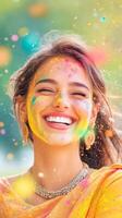 Woman in a saree joyfully celebrating Holi, throwing colorful gulal powder amidst lush greenery photo