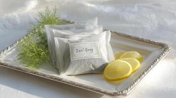 Delicate tray features Earl Grey tea pouches, bergamot slices, and a floral napkin under warm morning light photo