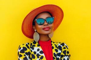 A fashionable black woman stands confidently in a cow print jacket against a bright yellow backdrop, radiating style photo